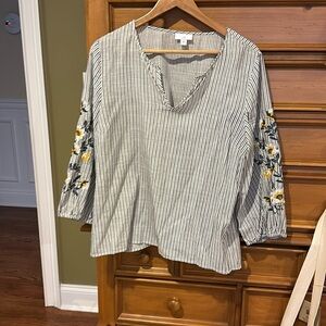 Embroidered sleeves on striped blouse